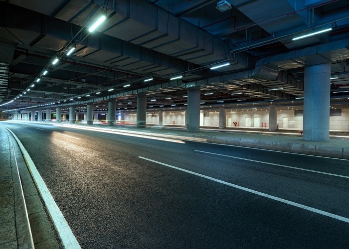 The inside of a well-lit, multi-lane tunnel