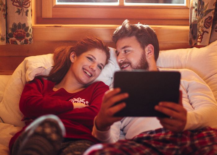 Smiling couple watching a tablet together