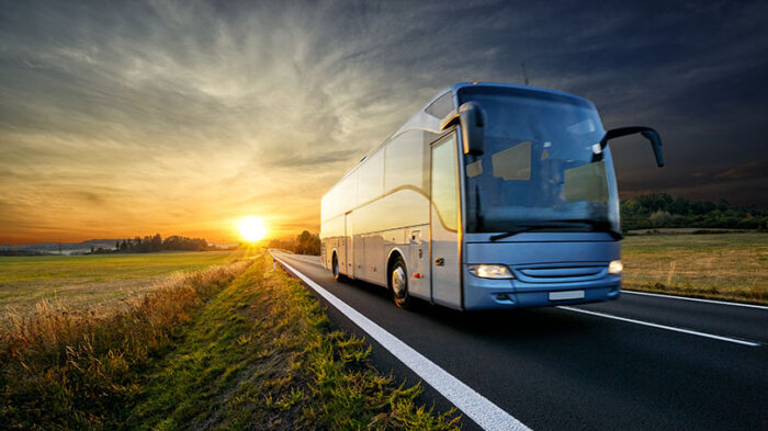 Buss på landevei i solnedgang