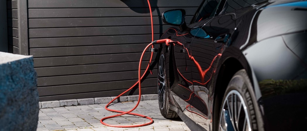 eConnect ev charging cable connected to home charger and Porsche Taycan