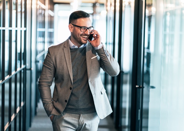 Man talking on phone in office corridor