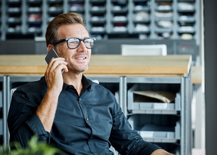 Mann snakker i mobiltelefon på kontor