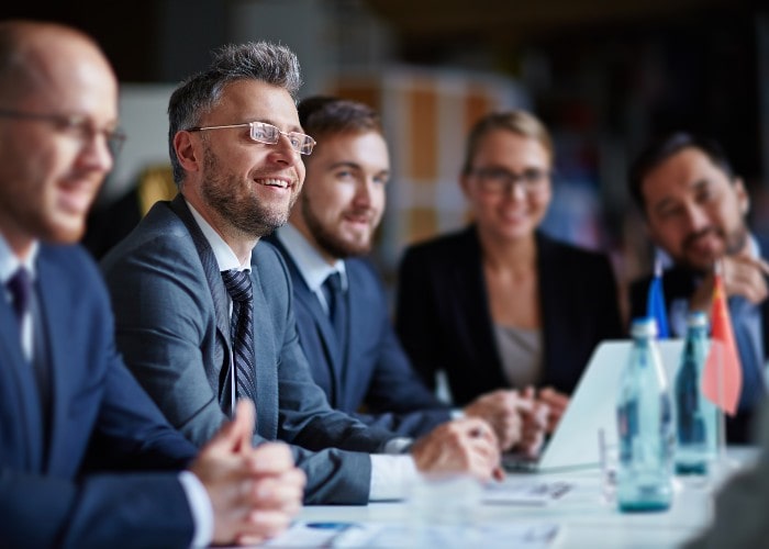 Man smiling in meeting room