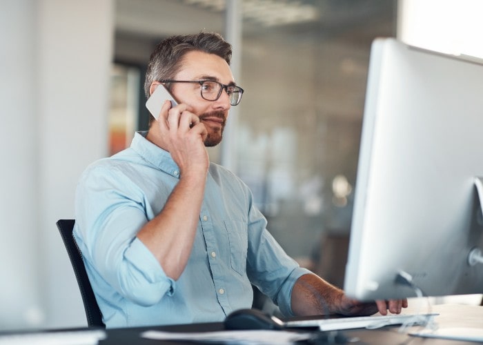 Man talking in mobile phone while working