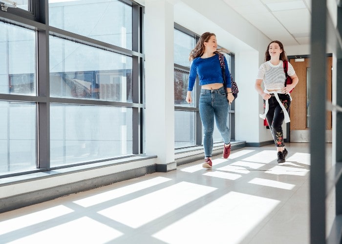 Teen girls in school hallway