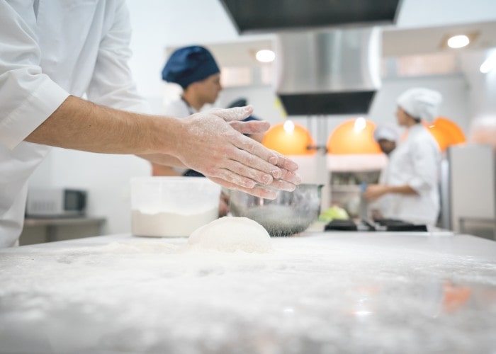 Chefs hands in school kitchen