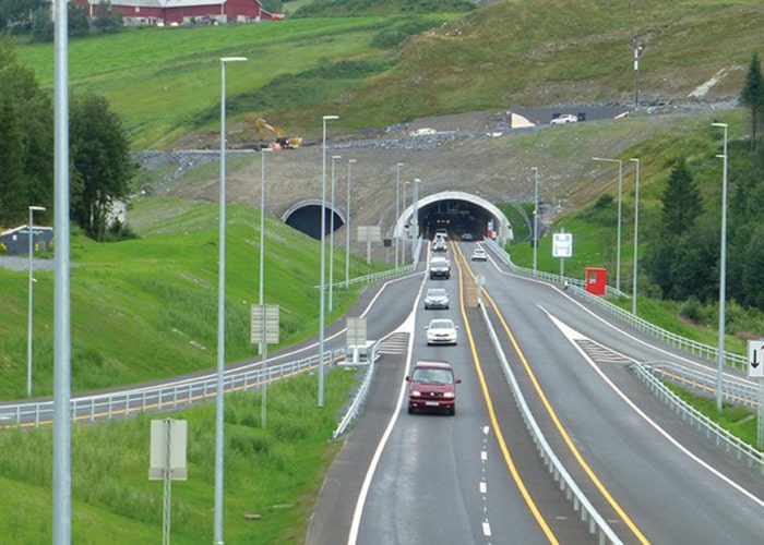 A highway and tunnel with road lights