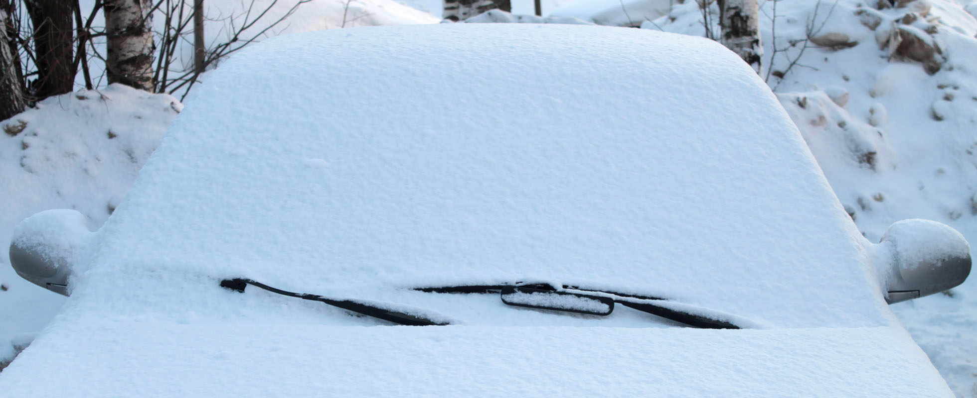 Car windshield covered by snow in the winter