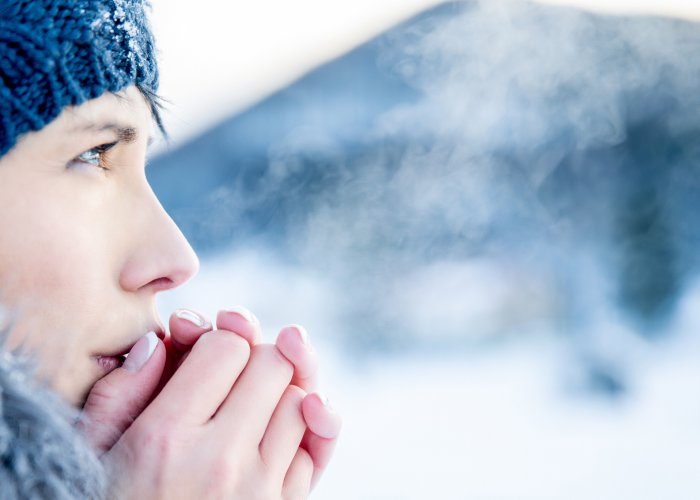 Woman breathing cloud in cold weather